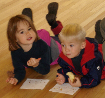 Kids enjoying doughnuts on the floor